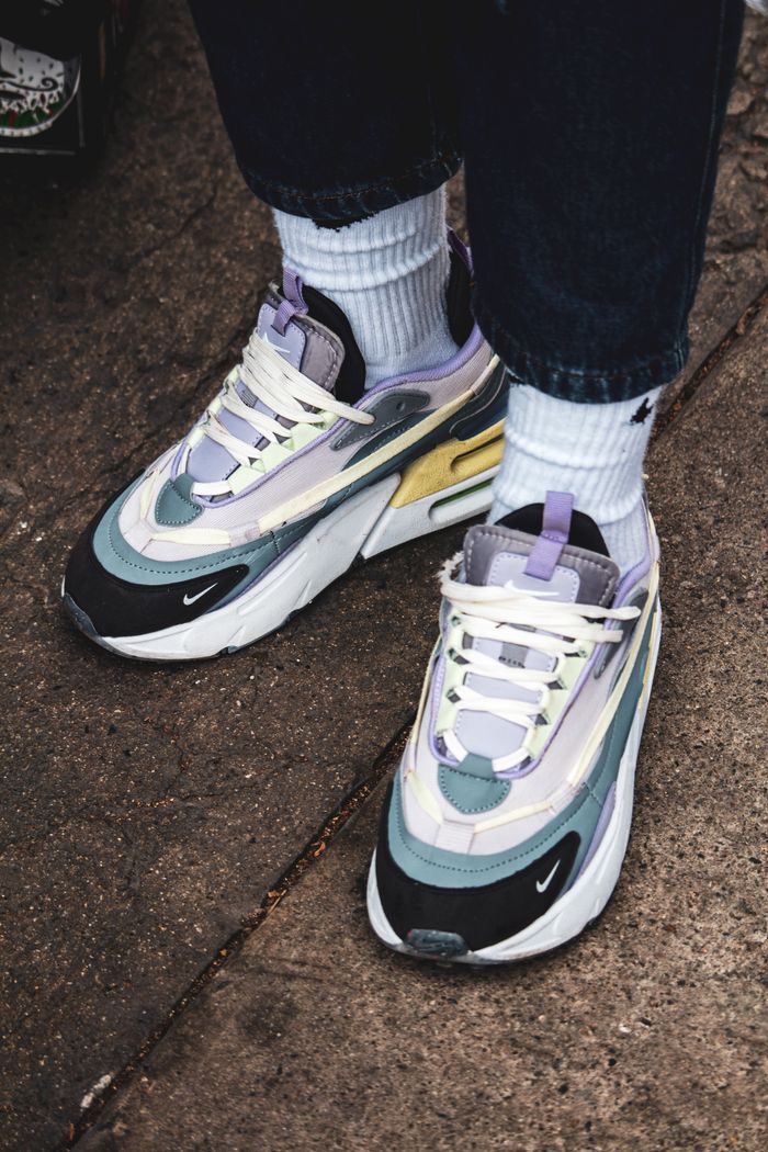 Colorful sneakers on concrete symbolize urban style and street fashion.